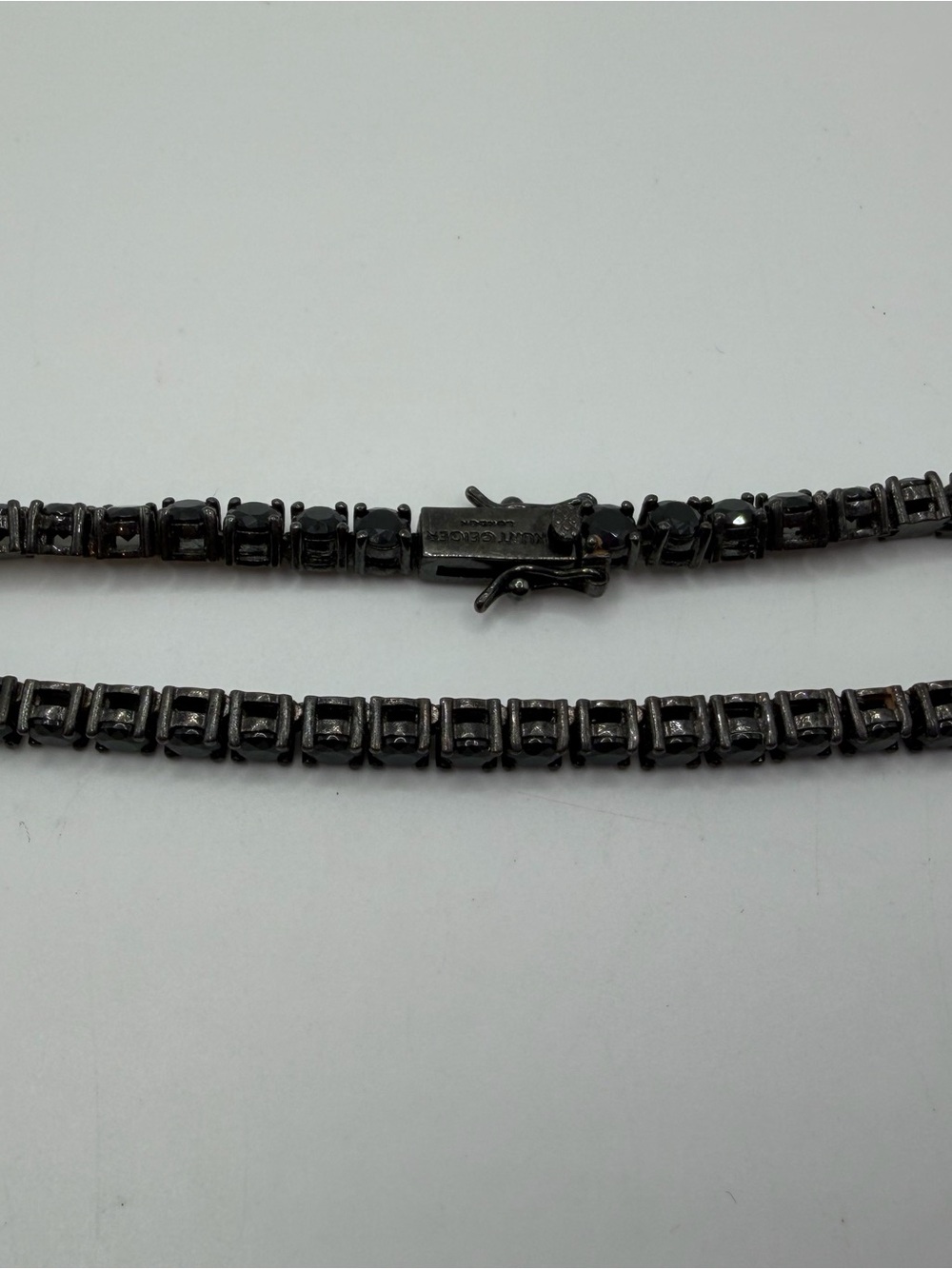 Kurt Geiger Womans Black Crystal Tennis Chain Bracelet “We are One”